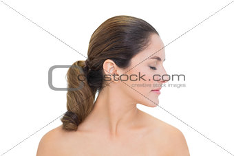 Peaceful bare brunette turning head right with closed eyes