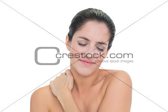 Sad bare brunette touching her neck
