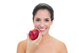 Smiling bare brunette holding red apple