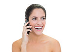 Laughing bare brunette phoning