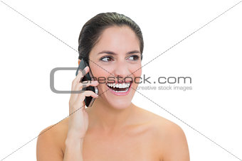 Laughing bare brunette phoning
