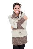 Smiling woman in winter fashion standing cross armed