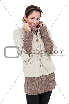Smiling cute brunette in winter fashion holding collar