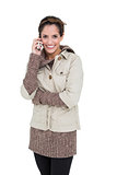 Smiling cute brunette in winter fashion phoning