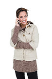 Happy cute brunette in winter fashion phoning