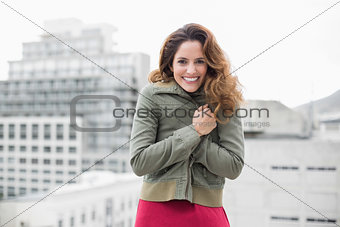 Gorgeous smiling brunette in winter fashion looking at camera
