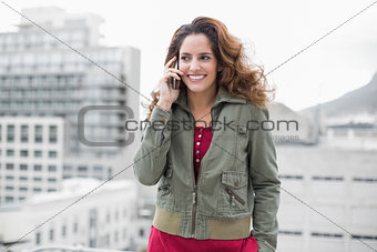 Smiling gorgeous brunette in winter fashion phoning