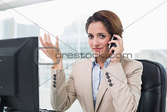 Gesturing businesswoman phoning