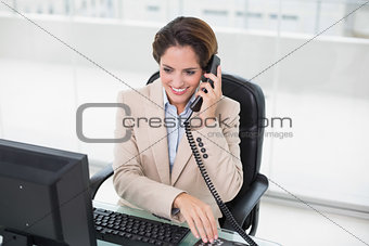 Smiling businesswoman using phone