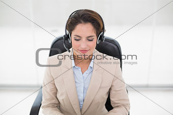 Happy call center agent sitting in swivel chair