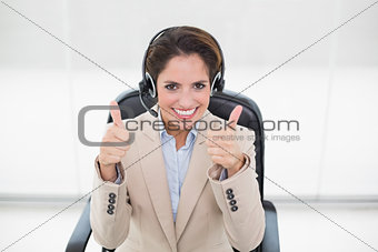 Smiling businesswoman showing thumbs up