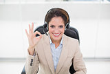 Happy businesswoman showing okay sign