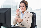 Smiling businesswoman pointing at computer