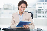 Smiling businesswoman looking at tablet