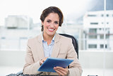 Smiling businesswoman holding tablet