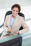 Happy businesswoman holding tablet