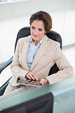 Thinking businesswoman holding tablet