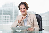 Smiling businesswoman holding newspaper