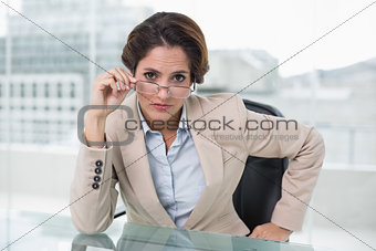 Dubious businesswoman looking at camera