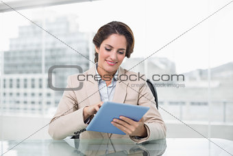 Businesswoman smiling and using her tablet pc