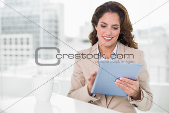 Beautiful smiling businesswoman using tablet