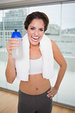 Sporty laughing brunette holding water bottle