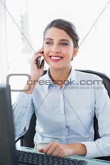 Content classy brown haired businesswoman making a phone call