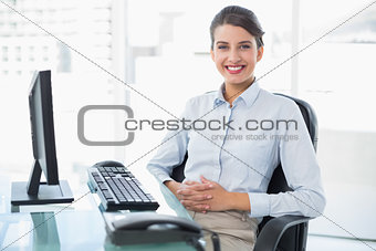 Cheerful classy brown haired businesswoman looking at camera