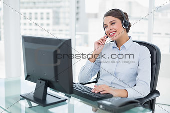 Joyful classy brown haired operator answering a call