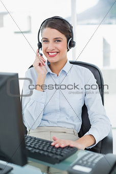 Pretty classy brown haired operator answering a call