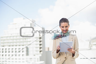 Content smart brown haired businesswoman using a tablet pc