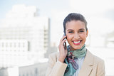 Pleased smart brown haired businesswoman making a phone call