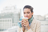Peaceful smart brown haired businesswoman enjoying coffee