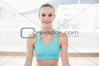 Sporty smiling woman sitting