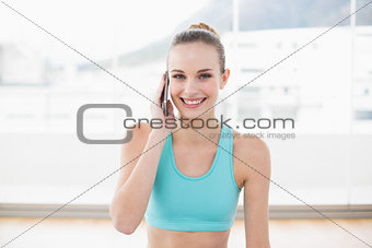 Sporty cheerful woman phoning