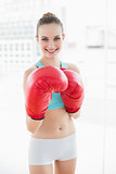 Sporty smiling woman boxing