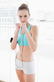Sporty serious woman listening to music