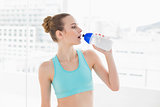 Sporty calm woman holding water bottle