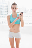 Sporty attractive woman looking at smartphone