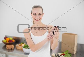 Happy young woman sending a texting
