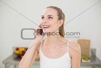 Happy young woman talking on smartphone