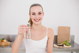 Happy young woman holding glass of water