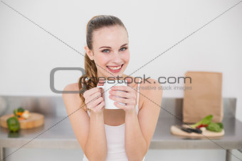 Smiling young woman holding mug