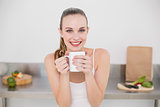 Happy young woman holding mug