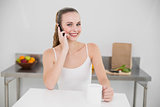 Smiling young woman making a phone call