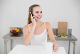 Happy young woman making a phone call