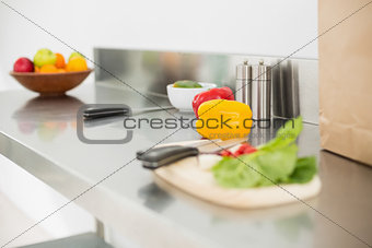 Vegetables and chopping board on a chrome counter