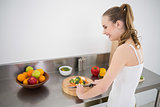 Pretty young woman preparing vegetables