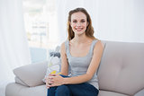 Happy young woman sitting on couch