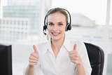 Happy call centre agent looking at camera giving thumbs up